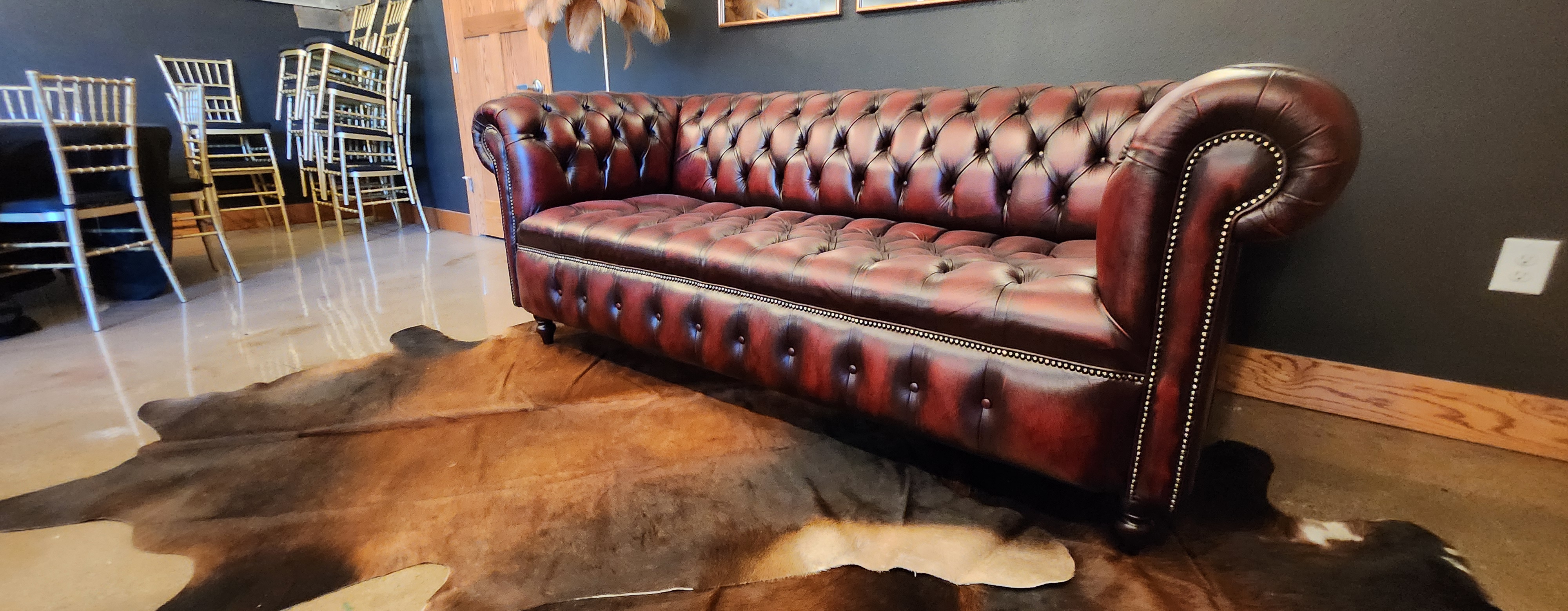 Leather lounge seating and warm event details inside The Back 30